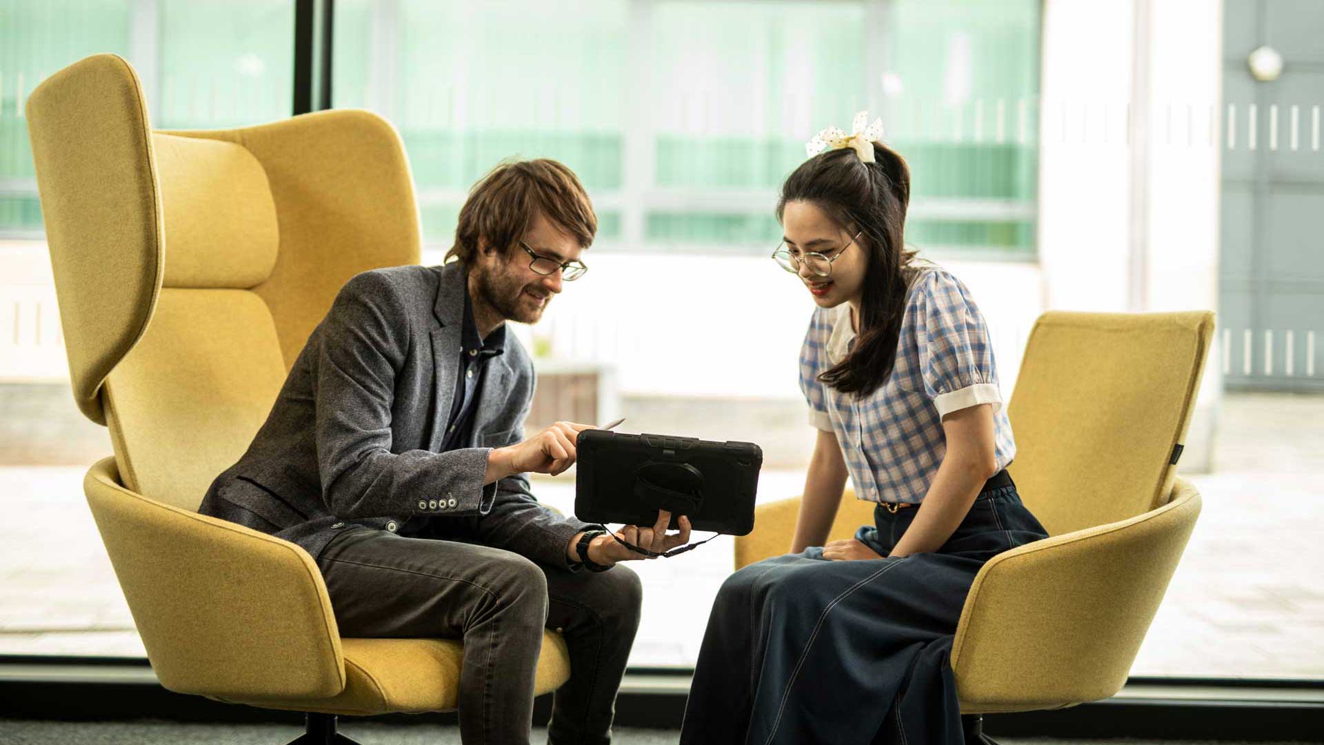 student and academic sat down with an ipad